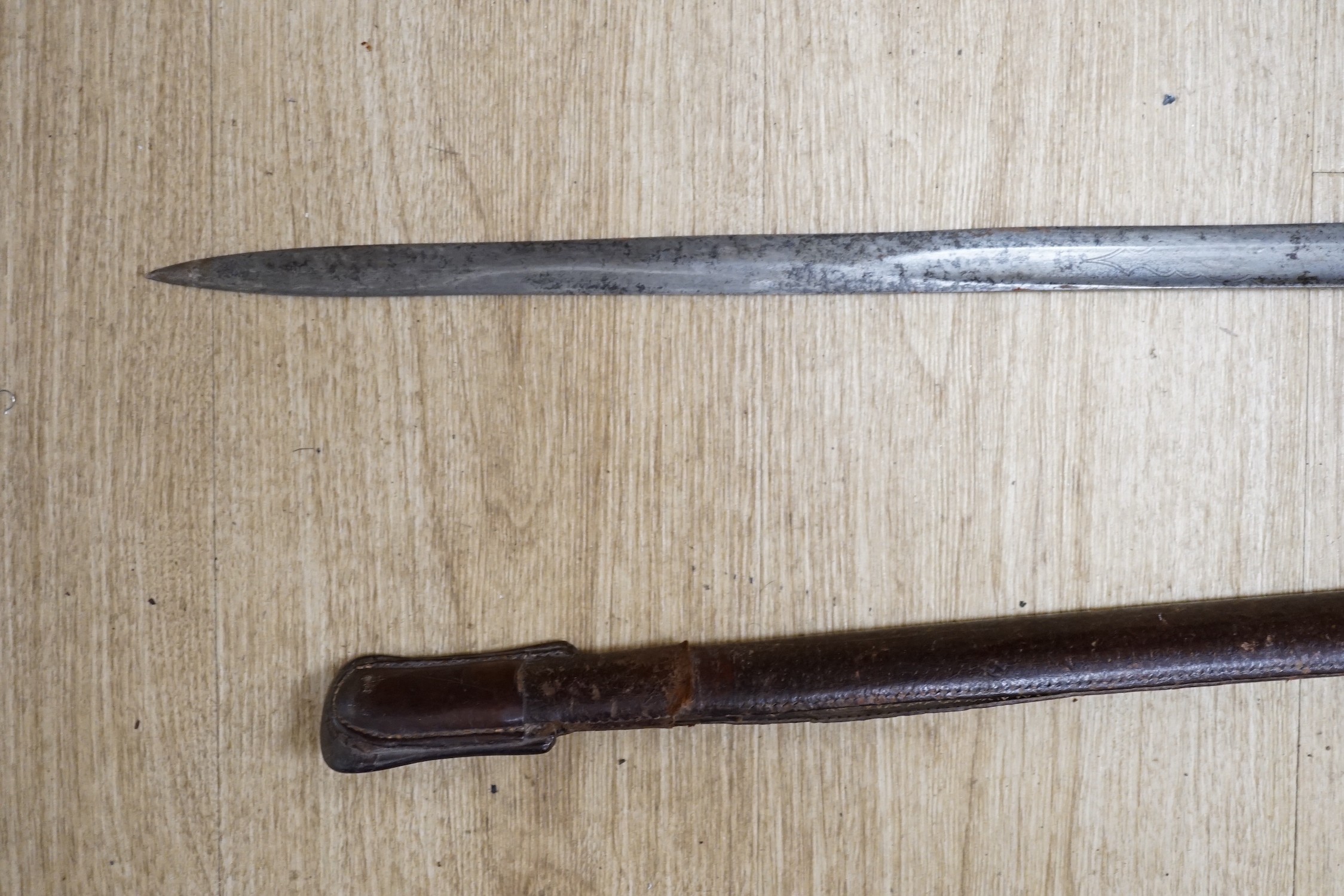 A George V dress sword, in a leather scabbard, 108cm long